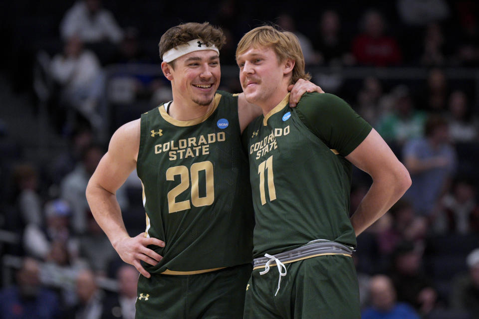 Colorado State's Jack Payne (11) stands with Joe Palmer (20) during the second half of the team's First Four college basketball game against Virginia in the men's NCAA Tournament, Tuesday, March 19, 2024, in Dayton, Ohio. (AP Photo/Jeff Dean)