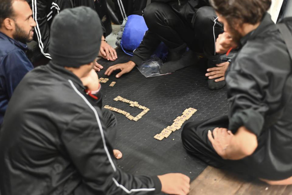 Part of the some 572 survivors rescued by the NGO Geo Barents rescue ship are packed on the deck of the ship cruising in the Mediterranean Sea, in this picture taken Sunday, Oct. 30, 2022. (Candida Lobes via AP)