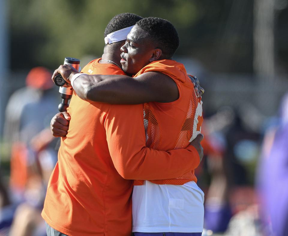 Clemson cornerback Andrew Booth Jr. (23) gets a hug from Tajh Boyd during a Cheez-It Bowl practice at Boone High School in Orlando, Florida Monday, December 27, 2021. 