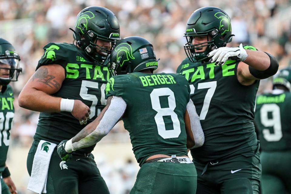 Michigan State's Jalen Berger, center, celebrates his touchdown with Nick Samac, left, and J.D. Duplain during the third quarter in the game against Akron on Saturday, Sept. 10, 2022, at Spartan Stadium in East Lansing.