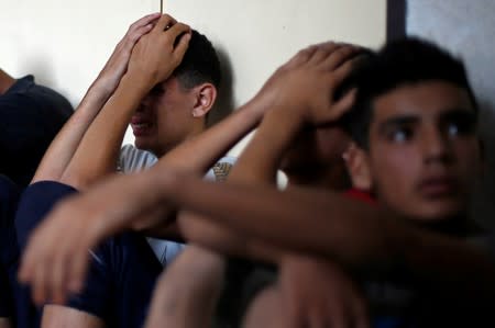 Relative of a Palestinian gunman who was killed by Israeli forces as he tried with others to cross the Gaza border, reacts at a hospital in the northern Gaza Strip