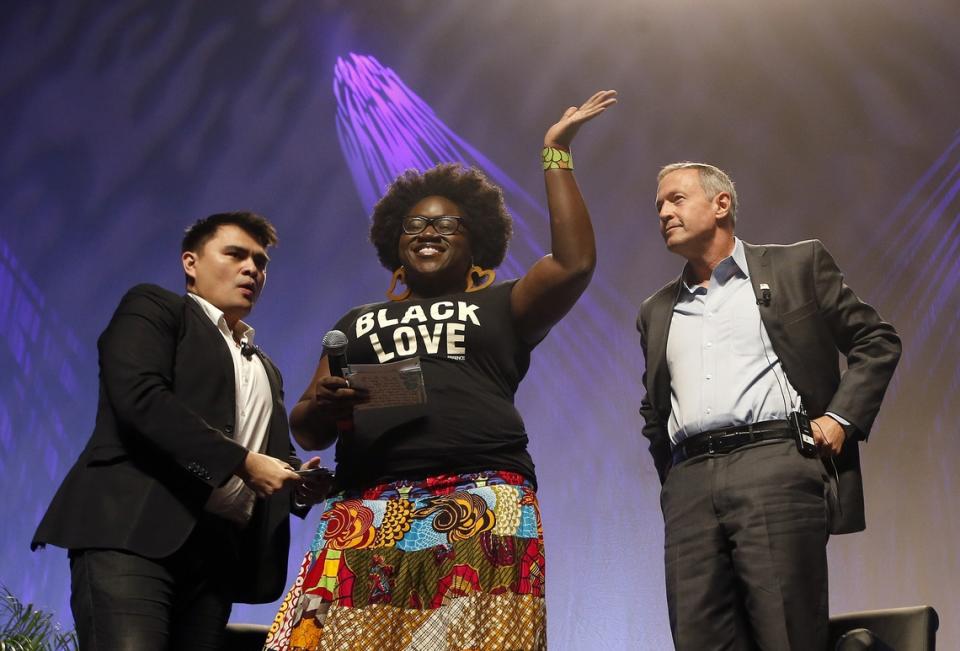 Netroots Nation 2015: Activist Tia Oso interrupts former Maryland Gov. Martin O’Malley (right) as moderator Jose Vargas watches  July 18, 2015, in Phoenix.