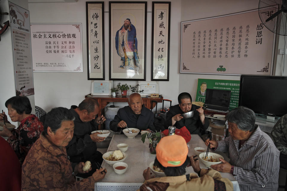 Elderly people having their free vegetarian lunch at Kang's canteen, the Harmonious and Happy Home, one of more than 80 operated by a charity for older people who live alone, in Dingxing, southwest of Beijing Thursday, May 13, 2021. China's leaders are easing limits on how many children each couple can have, hoping to counter the rapid aging of Chinese society.(AP Photo/Andy Wong)