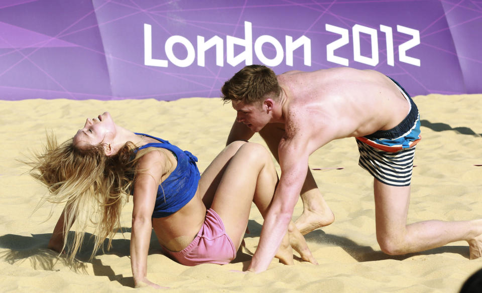 Dancers rehearse their performances for the London 2012 Olympic Beach Volleyball matches at the practice facility near to Horse Guards Parade in London July 24, 2012. (REUTERS/Olivia Harris)