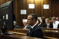 South African Olympic and Paralympic athlete Oscar Pistorius looks on during his murder trial in the North Gauteng High Court in Pretoria, April 16, 2014. Pistorius is on trial for murdering his girlfriend Reeva Steenkamp at his suburban Pretoria home on Valentine's Day last year. REUTERS/Gianluigi Guercia/Pool (SOUTH AFRICA - Tags: SPORT CRIME LAW)