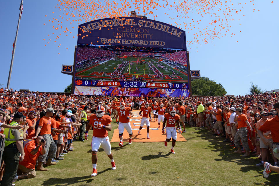 FILE- In this Sept. 7, 2013, file photo, Clemson players run down the hill before the start of an NCAA college football game against South Carolina State at Memorial Stadium in Clemson, S.C. Clemson is moving forward with plans to host its scheduled football game on Saturday while Hurricane Florence wreaks havoc on the Carolinas' coastline with officials bracing for historic flooding and record-setting rainfall that has forced people to evacuate their homes to escape the wrath of the storm. (AP Photo/Richard Shiro, File)