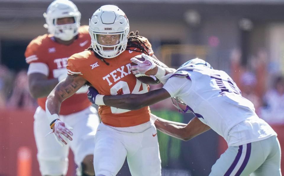 Texas running back Jonathon Brooks fights for yardage against Kansas State's Wesley Fair. Brooks ran for 112 yards while topping 1,000 yards for the season.