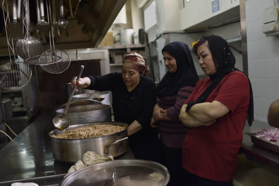 Women who made it out of some of the world's worst conflicts, like Syria and Afghanistan, cook alongside one another in the industrial kitchen of the City Plaza hotel.