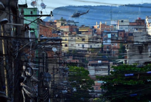 A police helicopter overflies the Favela da Mare shantytown complex in Rio de Janeiro in March 2014 -- the use of helicopters in police raids has increased in recent months