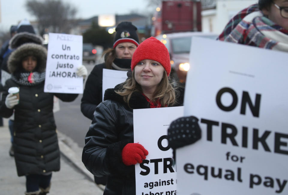 Charter school teachers including Vanessa Cerf-Nikolakakis, center, of Torres Elementary School, and other supporters walk the picket line outside the Acero's Zizumbo Elementary Charter school, Tuesday, Dec. 4, 2018, in Chicago. Hundreds of teachers have gone on strike at the Chicago charter school network, leading to canceled classes for thousands of students. (Antonio Perez/Chicago Tribune via AP)