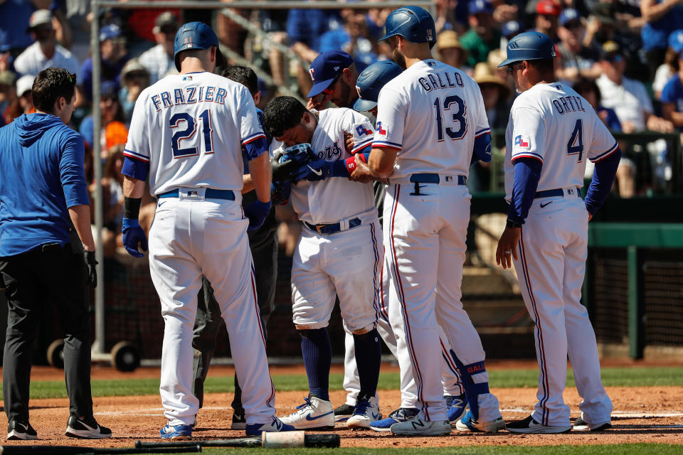 SURPRISE, AZ - MARCH 08: Texas Rangers left fielder Willie Calhoun (5) is helped up after he's hit by a pitch during the spring training MLB baseball game between the Los Angeles Dodgers and the Texas Rangers on March 8, 2020 at Surprise Stadium in Surprise, Arizona. (Photo by Kevin Abele/Icon Sportswire via Getty Images)