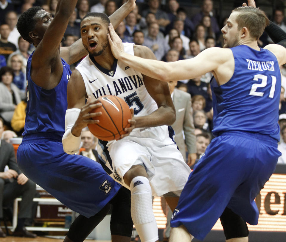 Villanova's Mikal Bridges gets a hand to the face as he drives by Creighton's Isaiah Zierden, right, during an NCAA college basketball game Saturday, Feb. 25, 2017, in Villanova, Pa. (Charles Fox/The Philadelphia Inquirer via AP)