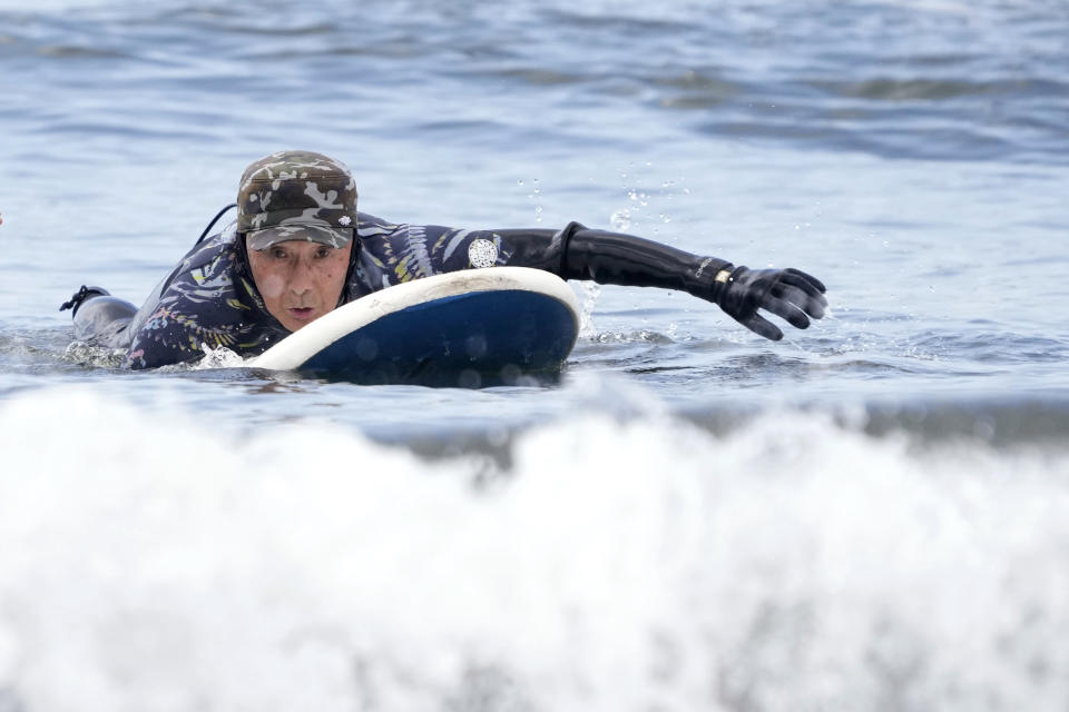 Seiichi Sano, an 89-year-old Japanese man, prepares riding a wave at Katase Nishihama Beach, Thursday, March 30, 2023, in Fujisawa, south of Tokyo. Sano, who turns 90 later this year, has been recognized by the Guinness World Records as the oldest male to surf. (AP Photo/Eugene Hoshiko)