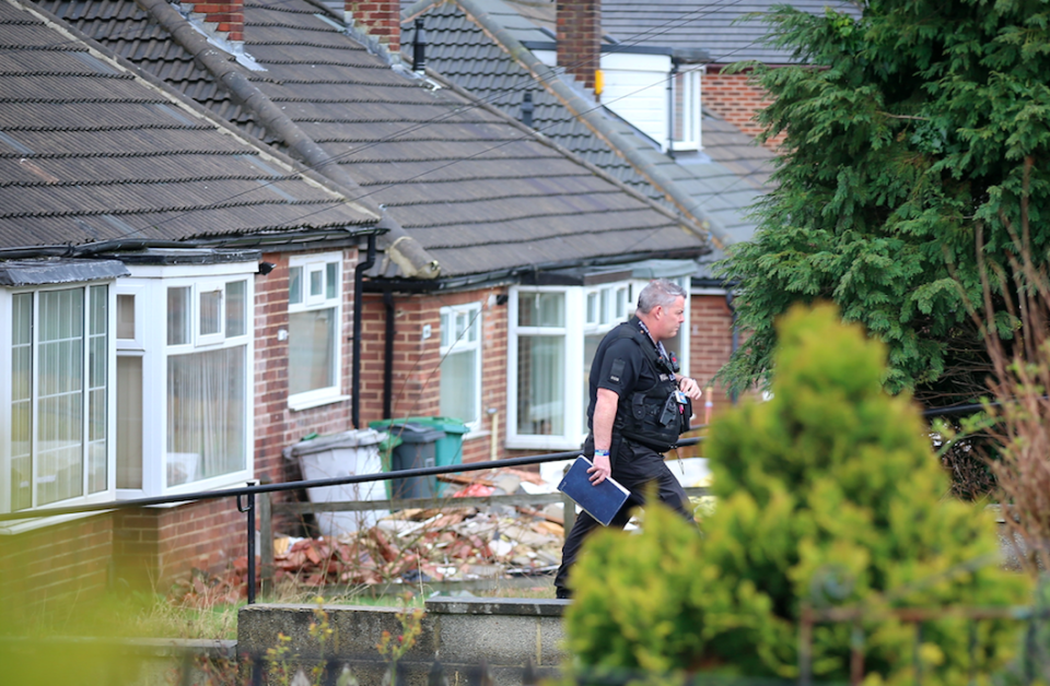 <em>Police investigate a house following the arrests (SWNS)</em>