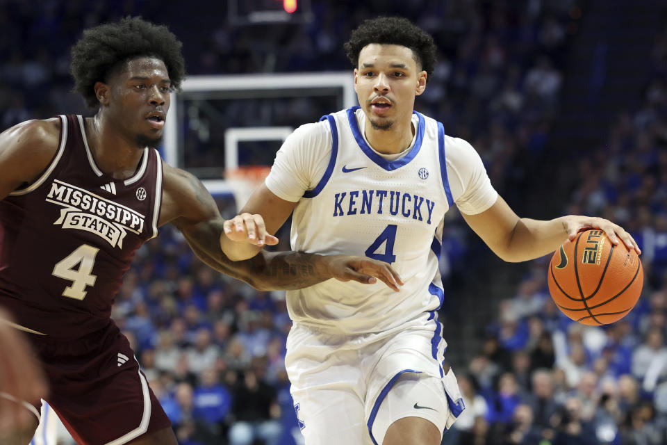 Kentucky's Tre Mitchell, right, drives while defended by Mississippi State's Cameron Matthews, left, during the second half of an NCAA college basketball game, Wednesday, Jan. 17, 2024, in Lexington, Ky. Kentucky won 90-77. (AP Photo/James Crisp)