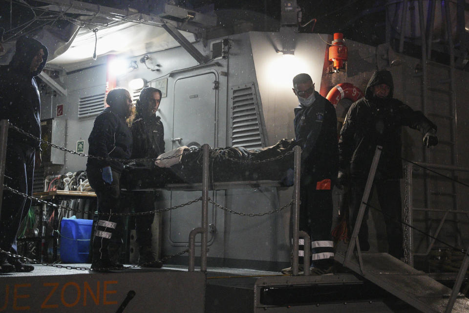 Paramedics carry the body of a crew member of a ship, on the northeastern Aegean Sea island of Lesbos, Greece, Sunday, Nov. 26, 2023. A cargo ship sank off the Greek island of Lesbos early Sunday, leaving 13 crew members missing and one rescued, authorities said. The Raptor, registered in the Comoros, was on its way to Istanbul from Alexandria, Egypt, carrying 6,000 tons of salt, the coast guard said. It had a crew of 14, including eight Egyptians, four Indians and two Syrians, the coast guard said. (AP Photo/Panagiotis Balaskas)