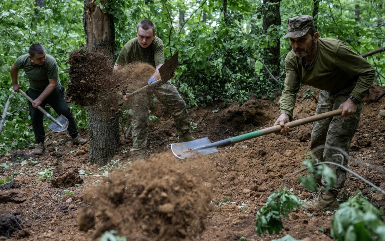 Ukrainian artillerymen set up positions on the front line near the town of Vovchansk