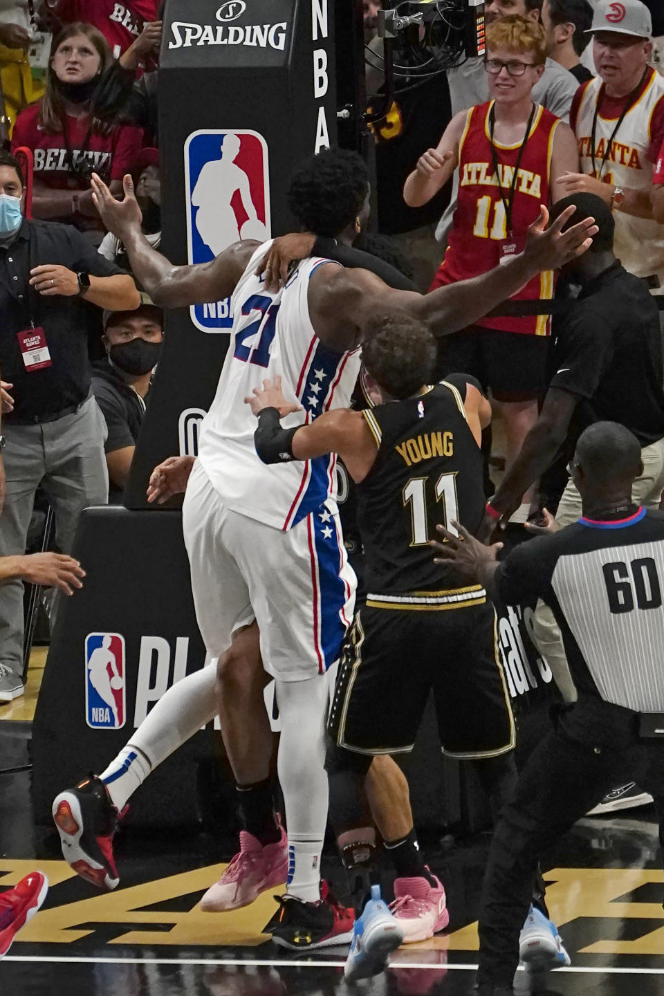 Philadelphia 76ers center Joel Embiid (21) and Atlanta Hawks forward John Collins (20) are separated after a brief altercations during the second half of Game 6 of an NBA basketball Eastern Conference semifinal series Friday, June 18, 2021, in Atlanta. (AP Photo/John Bazemore)