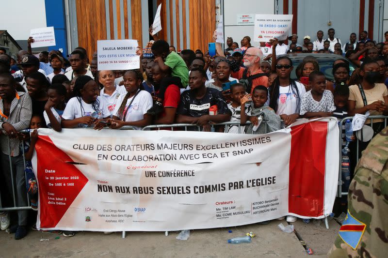 Members of Ending Clergy Abuse (ECA) hold a protest in front of the Cathedral Notre Dame De Lingwala in Kinshasa