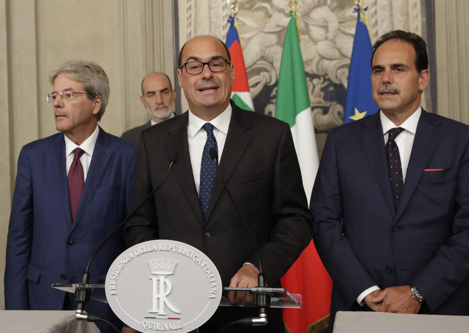 Democratic Party leader Nicola Zingaretti, center, talks to the press after meeting Italian President Sergio Mattarella, in Rome, Thursday, Aug. 22, 2019. President Sergio Mattarella continued receiving political leaders Thursday, to explore if a solid majority with staying power exists in Parliament for a new government that could win the required confidence vote. At left is former premier Paolo Gentiloni, at right Andrea Marcucci. (AP Photo/Alessandra Tarantino)