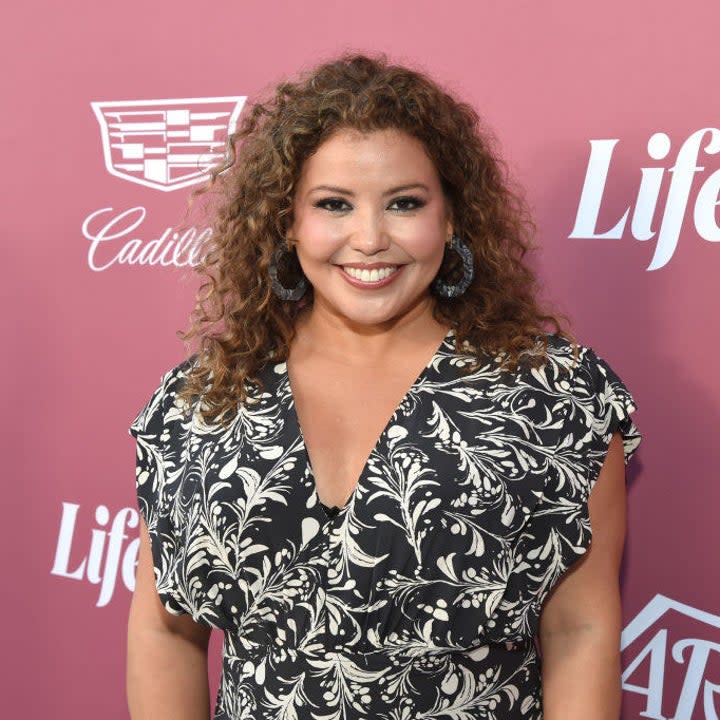 Justina Machado posting on a red carpet