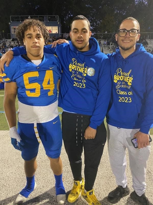 North Brunswick High School football player Katrell Pereira (left) with brothers Tyrell (center) and Khalil (right)