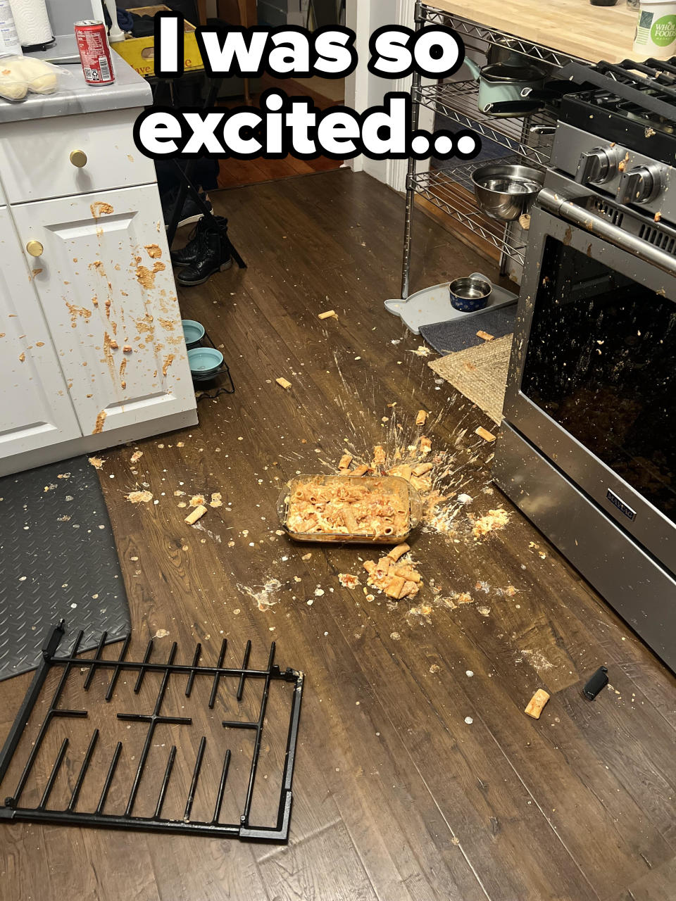 Baked dish splattered on kitchen floor near stove, with broken oven rack and scattered debris