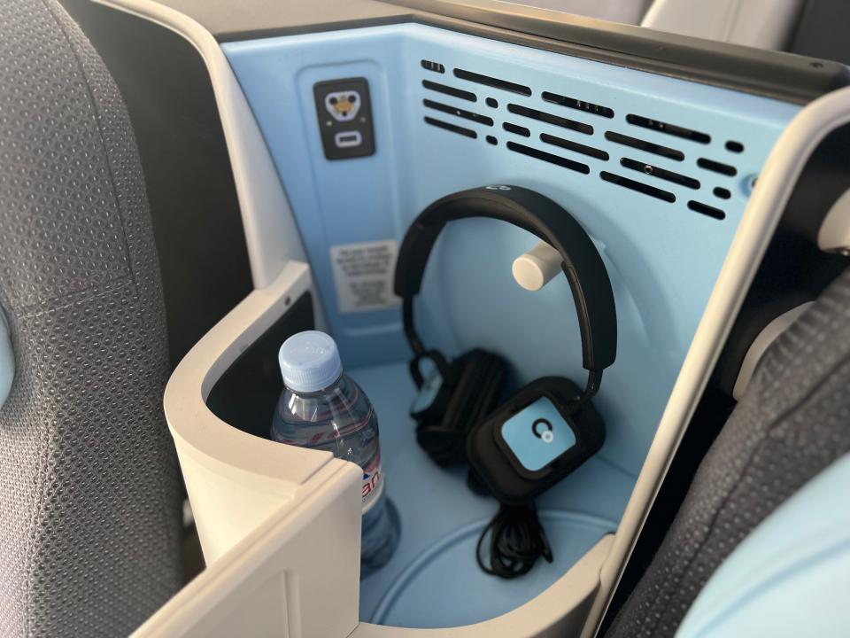 Flying on La Compagnie all-business class airline from Paris to New York — a pair of headphones next to power sockets.