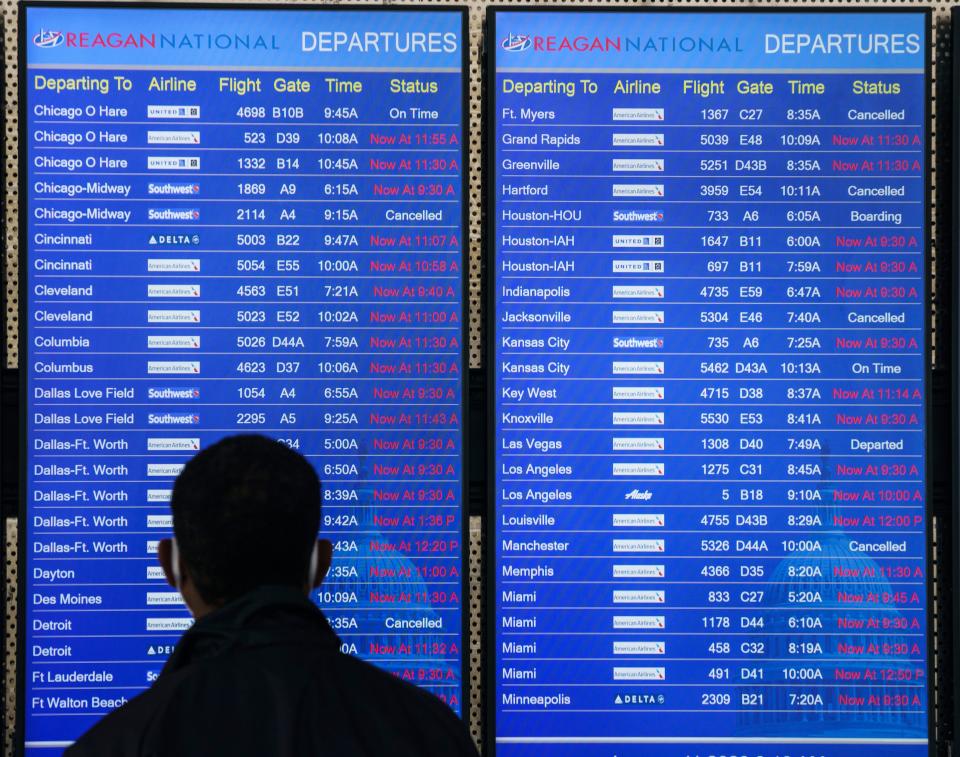 Travelers navigate delays caused by an FAA system outage at Ronald Reagan Washington National Airport on Wednesday in Arlington, Va.