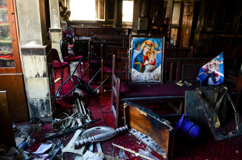 Burned furniture, including wooden tables and chairs, and religious images are seen at the site of a fire inside the Abu Sifin Coptic church that killed at least 40 people and injured some 14 others, in the densely populated neighborhood of Imbaba, Cairo, Egypt, on Aug. 14, 2022. (Tarek Wajeh / AP)