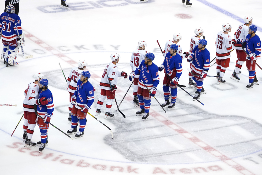 Members of the Carolina Hurricanes and New York Rangers at the conclusion of their Stanley Cup playoff series Aug. 4.