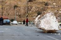 <p>An Iraqi Kurdish man walks by a large rock which fell from the top of a mountain during the earthquake that hit Darbandikhan town, near Sulaymaniya city, northern Iraq on Nov. 13, 2017. (Photo: Abedin Taherkenareh/EPA-EFE/REX/Shutterstock) </p>