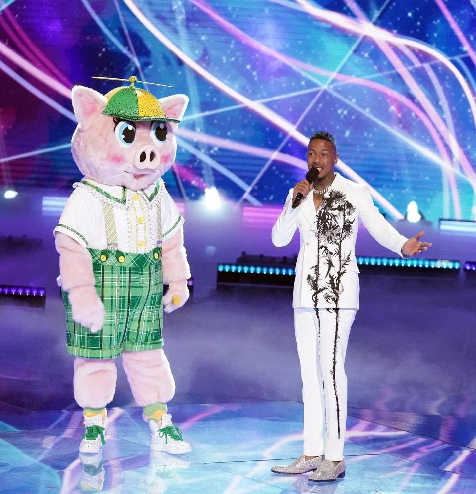 "Masked Singer" contestant Piglet with the show's host, Nick Cannon.