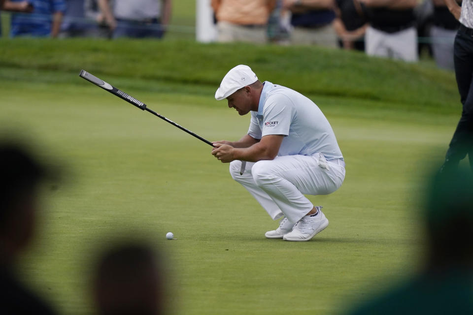 Bryson DeChambeau eyes his putt on the third green during the second round of the Rocket Mortgage Classic golf tournament, Friday, July 2, 2021, at the Detroit Golf Club in Detroit. (AP Photo/Carlos Osorio)