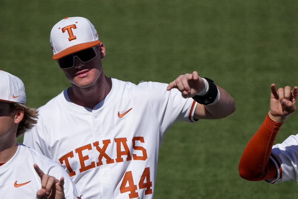 Texas outfielder Max Belyeu holds up the Hook 'em sign during the playing of "The Eyes of Texas" ahead of the game against Cal Poly at UFCU Disch–Falk Field on Feb. 24. He leads the team with 11 home runs this season.