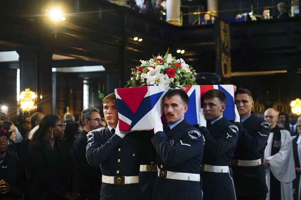 People gather for the funeral of former RAF Sergeant Peter Brown originally from Jamaica, at St Clement Danes Church, in London, Thursday May 25, 2023. Flight Sgt. Peter Brown who flew bombing missions in World War II after volunteering for the Royal Air Force died in December, aged 96. Volunteers tried to track down family and people who knew him. Word of that search drew interest from others who didn't want him to be forgotten for the service he offered in Britain's darkest hour. (Victoria Jones/PA via AP)