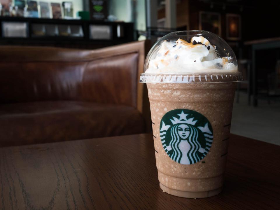 Starbucks Frappuccino sitting on a wood coffee table