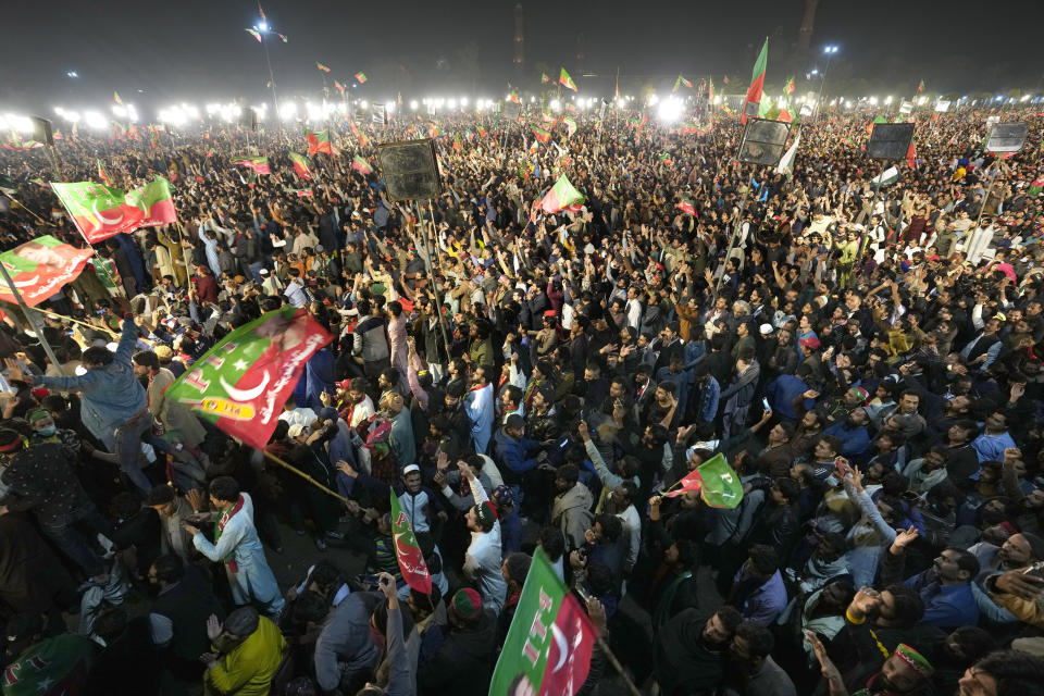 Supporters of former Prime Minister Imran Khan listen to his speech during a rally in Lahore, Pakistan, Sunday, March 26, 2023, to pressure the government of Shahbaz Sharif to agree to hold snap elections. (AP Photo/K.M. Chaudary)