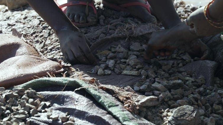 Close up of hands washing ore.