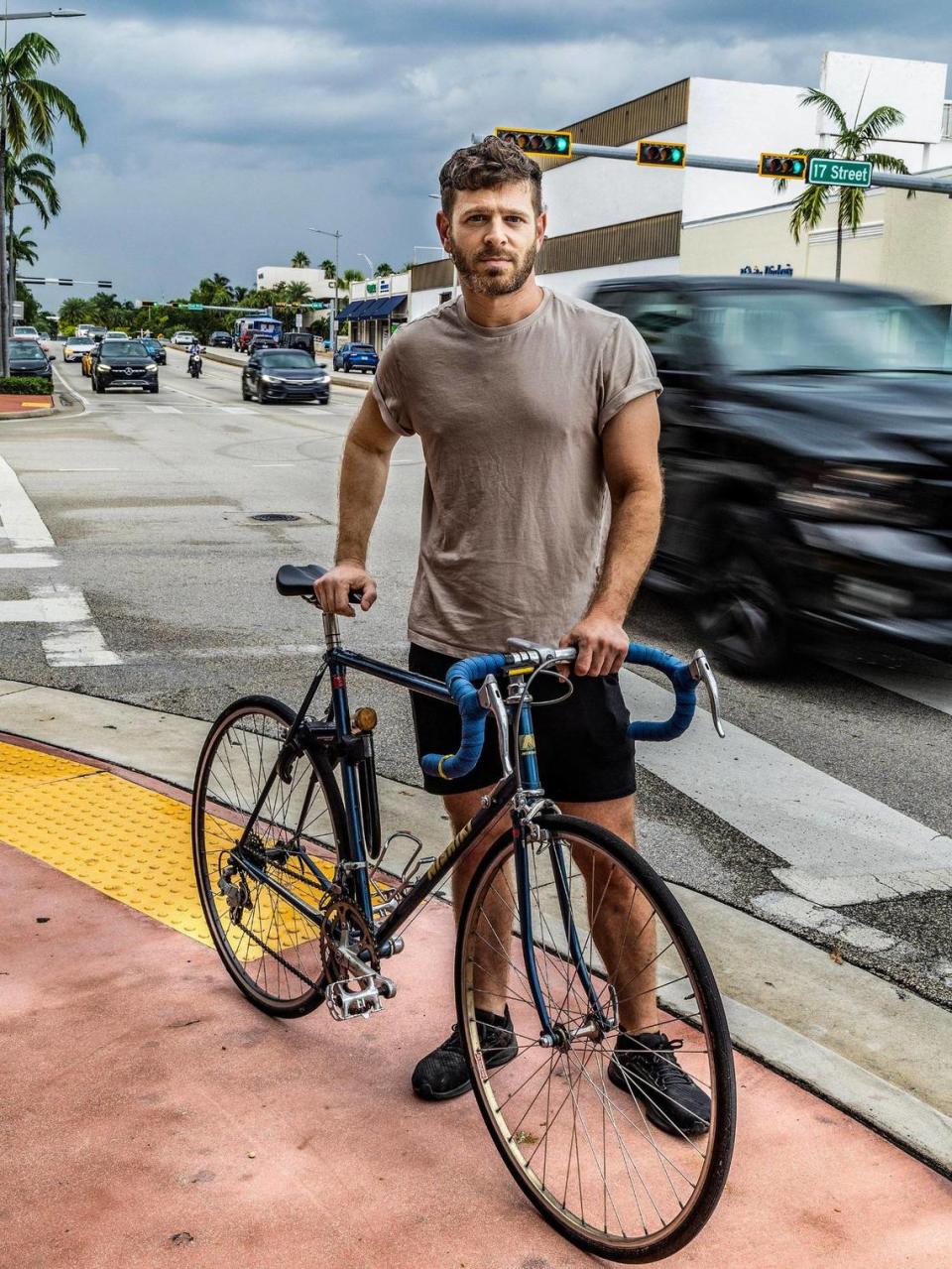 Jeremy Sapienza stands at the corner of Alton Road and 17th Street in Miami Beach, where he was involved in a road rage incident as he biked in the street near his house, on July 7, 2023. Pedro Portal/pportal@miamiherald.com