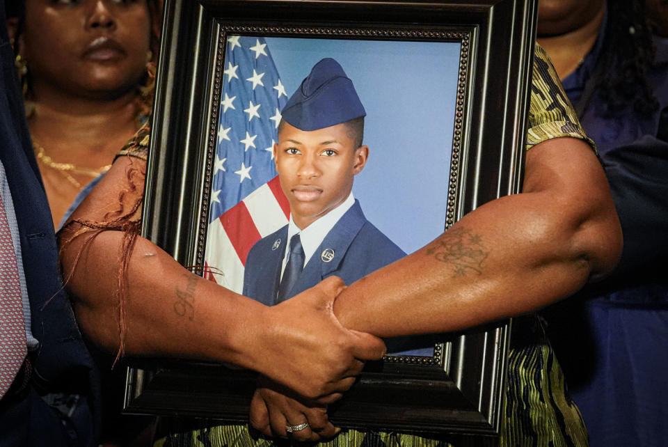 Chantemekki Fortson, mother of Roger Fortson, holds a photo of her son during a press conference.  (Gerald Herbert/AP)