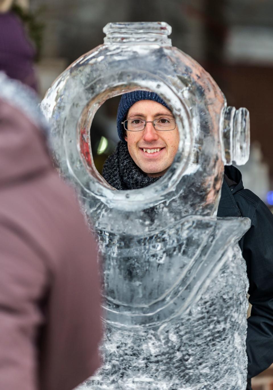 Joe Alberth of Delafield poses for a photo with an ice sculpture during the 4th annual DelaFREEZE event in downtown Delafield on Saturday, Jan. 08, 2022. The event, hosted by the Delafield Chamber of Commerce, features a variety of winter-themed attractions.