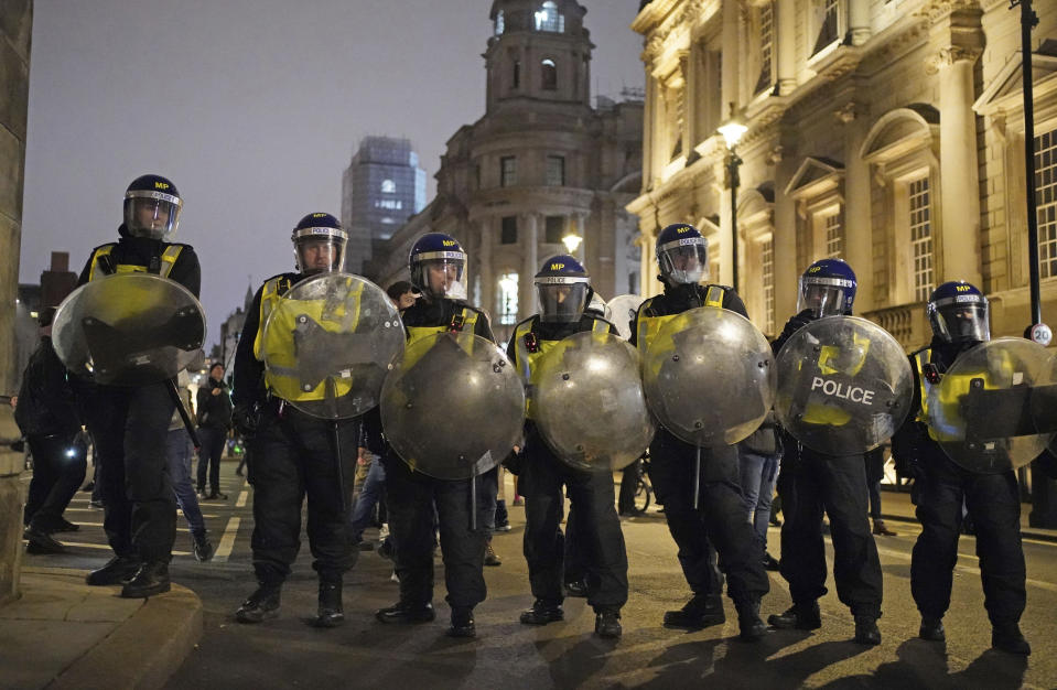 Police in riot gear during an anti COVID-19 vaccination demonstration on Whitehall, in London, Saturday, Dec. 18, 2021. Hundreds of people protested in London Saturaday, blocking traffic as they marched with signs bearing slogans such as “Vaccine passports kill our freedoms” and “Don’t comply.” (Dominic Lipinski//PA via AP)