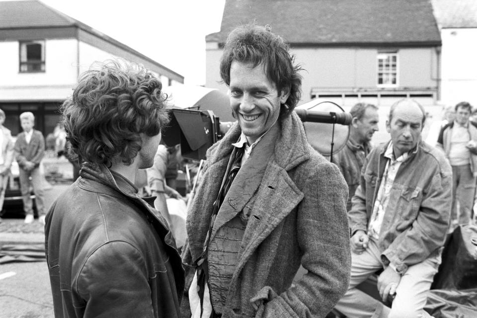 British actors Paul McGann and Richard E. Grant film a scene in Stony Stratford, Buckinghamshire, for the movie 'Withnail & I', 1986. (Photo by Murray Close/Getty Images)