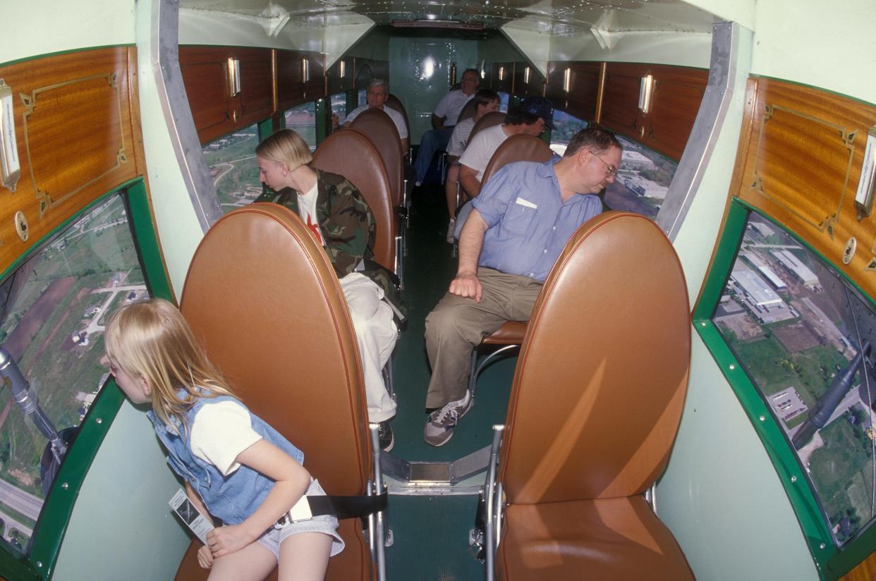 Experimental Aircraft Association passengers enjoy a ride on the Ford Tri-Motor, an airplane manufactured in 1929.