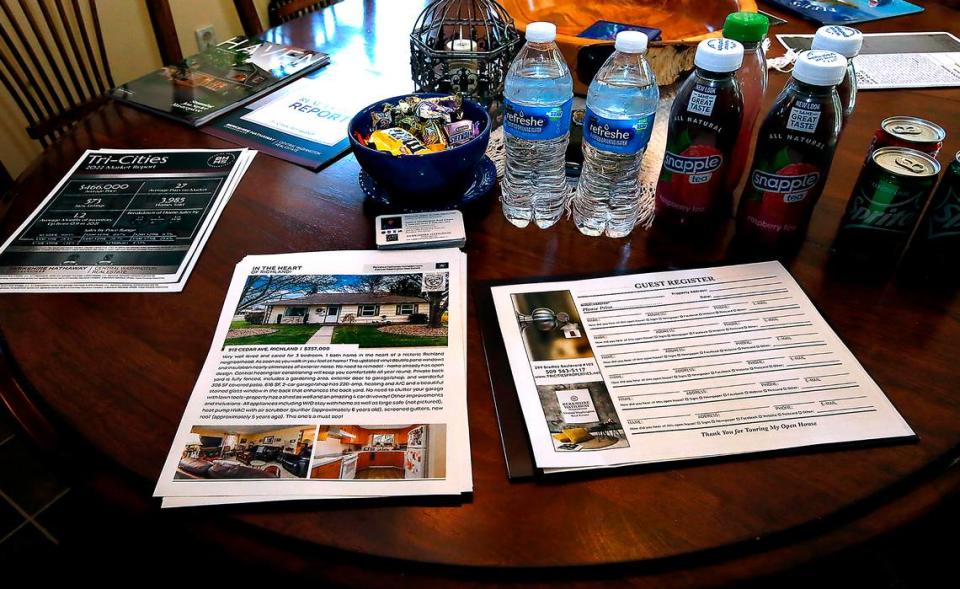 Informational sheets and refreshments are set out on the dining room table during a recent open house in Richland.