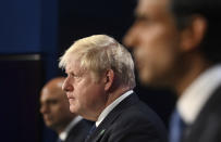 FILE - In this Tuesday, Sept. 7, 2021 file photo, from left, Britain's Health Secretary Sajid Javid, Prime Minister Boris Johnson and Chancellor of the Exchequer Rishi Sunak attend a media briefing in Downing Street, London. Johnson was dealt a major blow Tuesday, July 5, 2022 when two of his most senior Cabinet ministers quit, saying they had lost confidence in Johnson’s leadership. (Toby Melville/Pool Photo via AP, File)