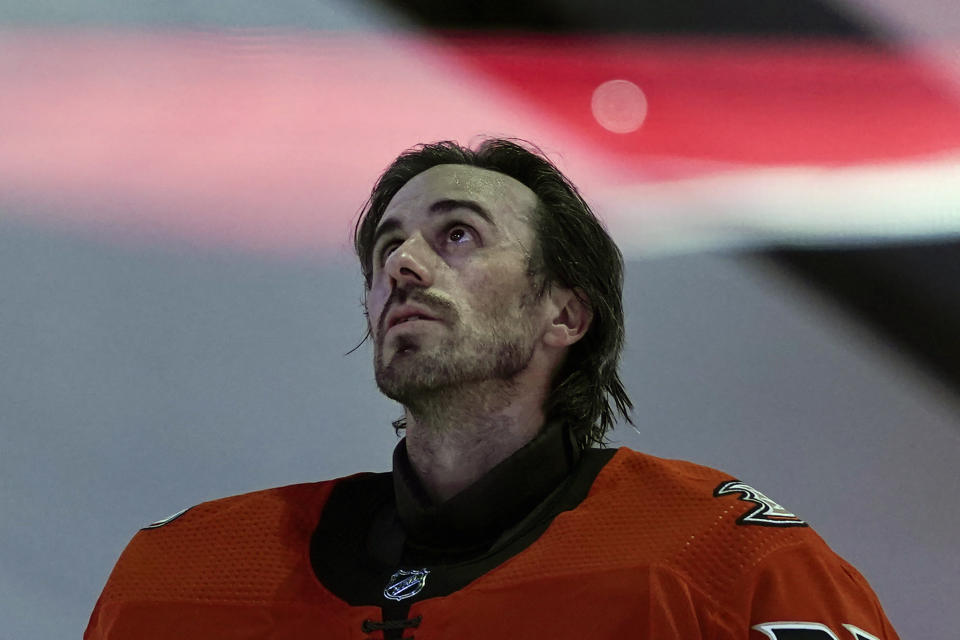 FILE - Anaheim Ducks goaltender Ryan Miller listens to the national anthem before the team's NHL hockey game against the Los Angeles Kings, Saturday, May 1, 2021, in Anaheim, Calif. The Buffalo Sabres are honoring their franchise goalie leader in wins and games played by retiring Ryan Miller's No. 30 jersey next season. The team made the announcement by releasing a video on Friday, June 10, 2022, which showed Miller being informed of the honor while touring the Sabres arena with his family. (AP Photo/Jae C. Hong, File)