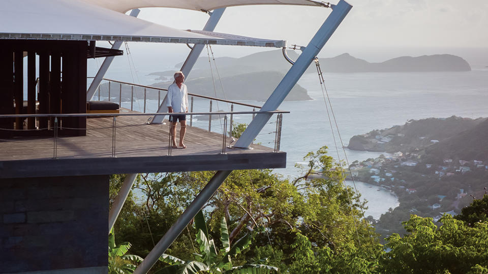 Mike Wilkie on the deck of the Sail House, a home Hertz designed in Bequia, St. Vincent and the Grenadines. - Credit: Courtesy of Kevin Scott