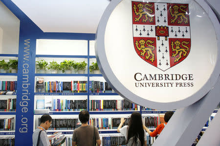 People look at books at the stall of Cambridge University Press (CUP) at the Beijing International Book Fair in Beijing, China, August 23, 2017. REUTERS/Thomas Peter